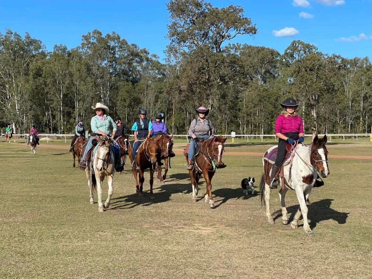 a group of people riding horses on a cowgirl camp
