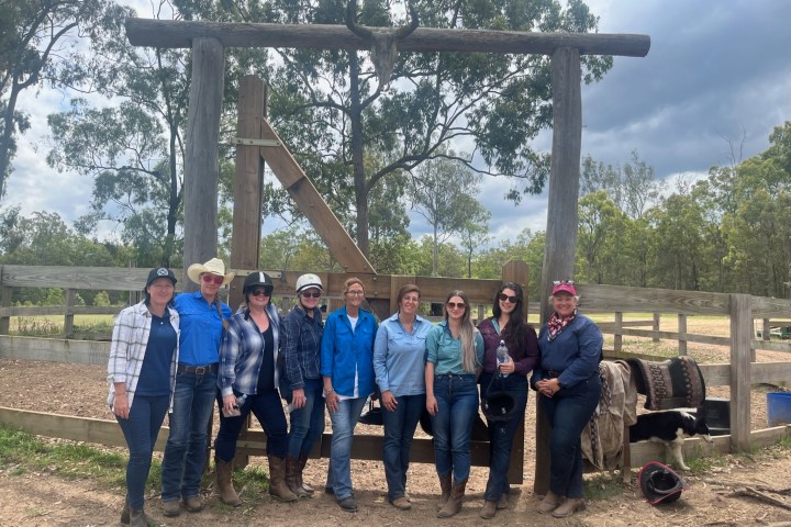 a group of people posing for the camera on a cowgirl camp